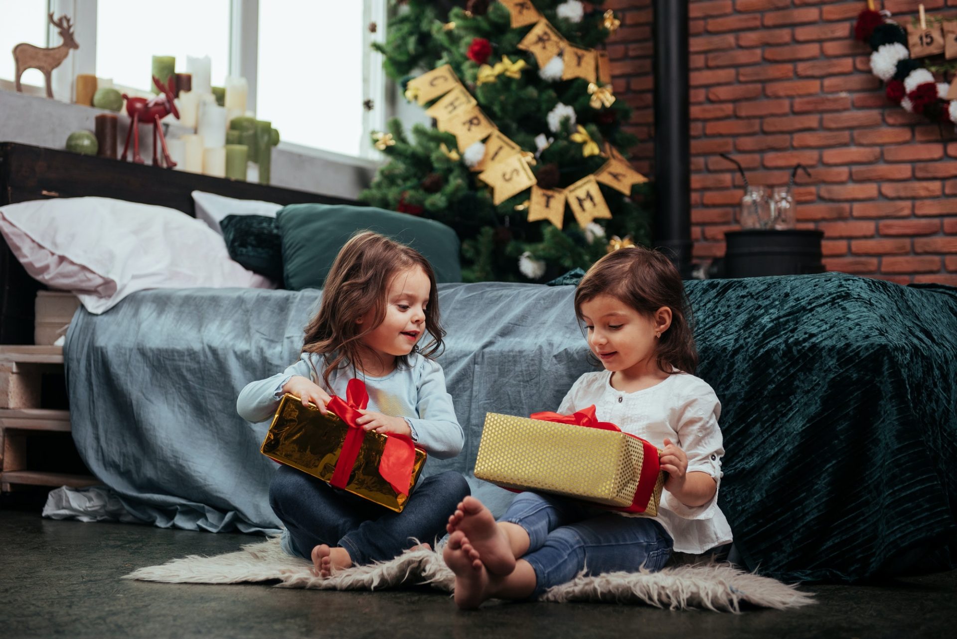 Christmas holidays with gifts for these two kids that sitting indoors